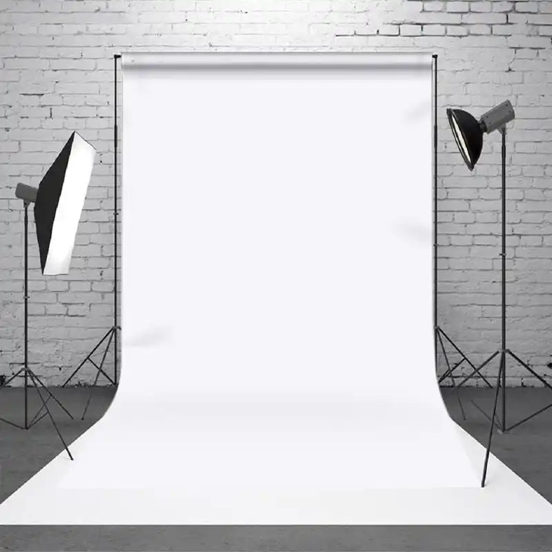 White photography backdrop paper seamlessly draped from top to bottom.